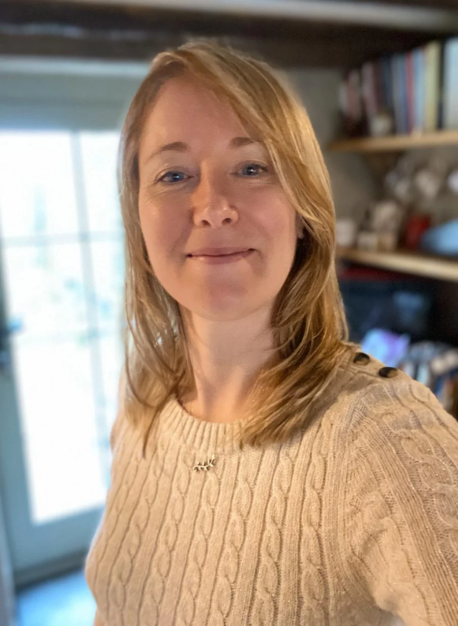 Melanie preparing food in a charming, rustic kitchen.