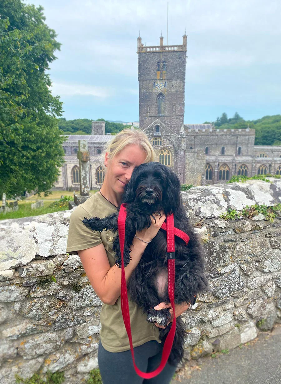 Melanie standing outside the historic St. Davids Cathedral in Wales.
