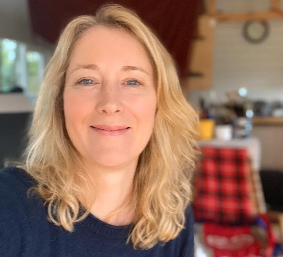 Melanie focused on her artwork, drawing in her light-filled art studio.