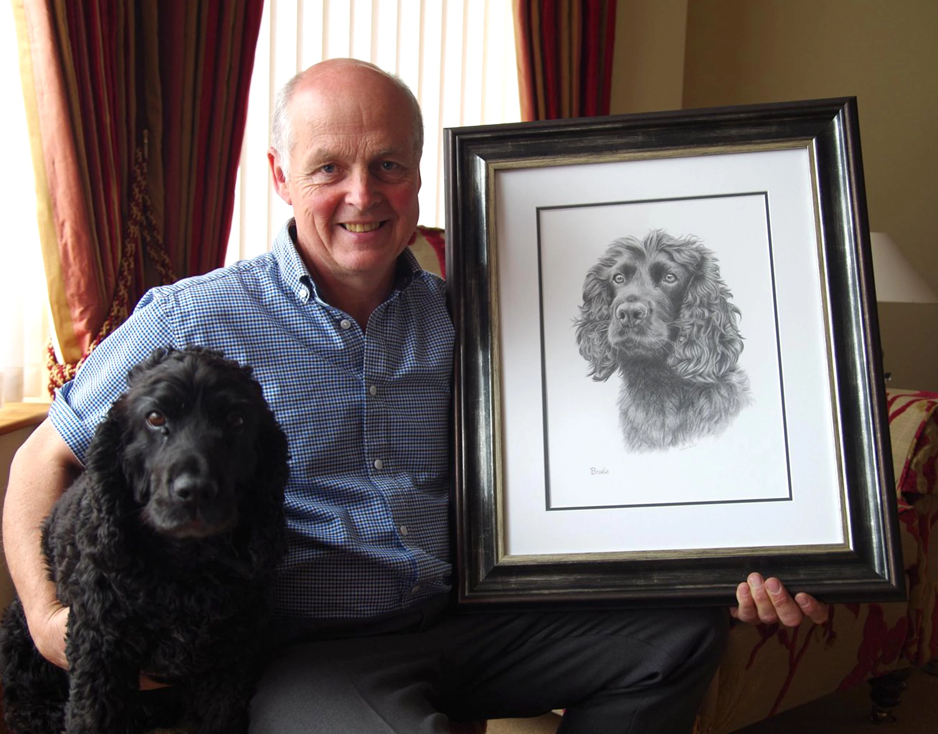 The finished pencil portrait of Brodie, a Spaniel, showing his detailed fur and expression.